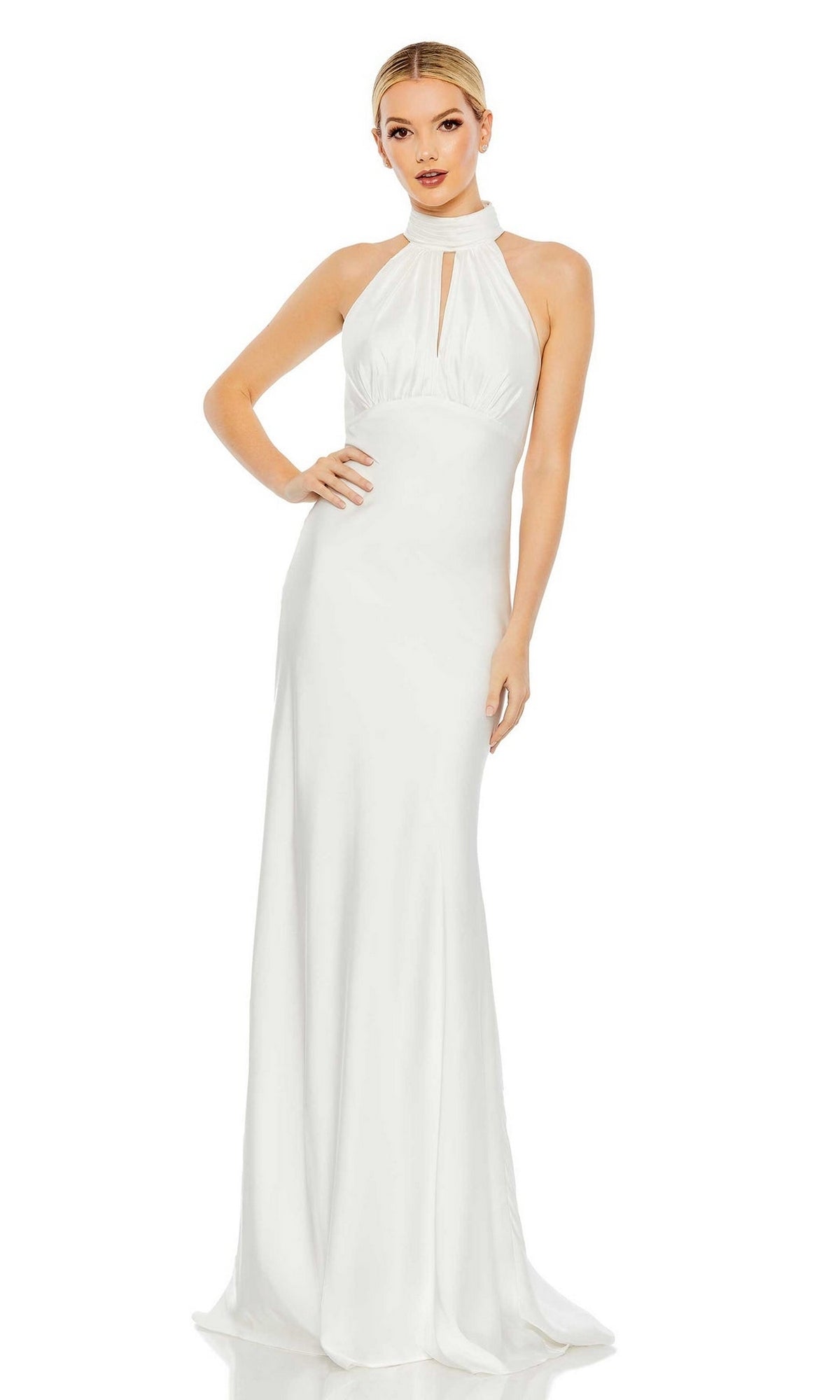 A woman poses against a white background wearing the Long Formal Dress 49520 by Mac Duggal—a sleeveless, floor-length keyhole empire waist dress with a halter neckline.